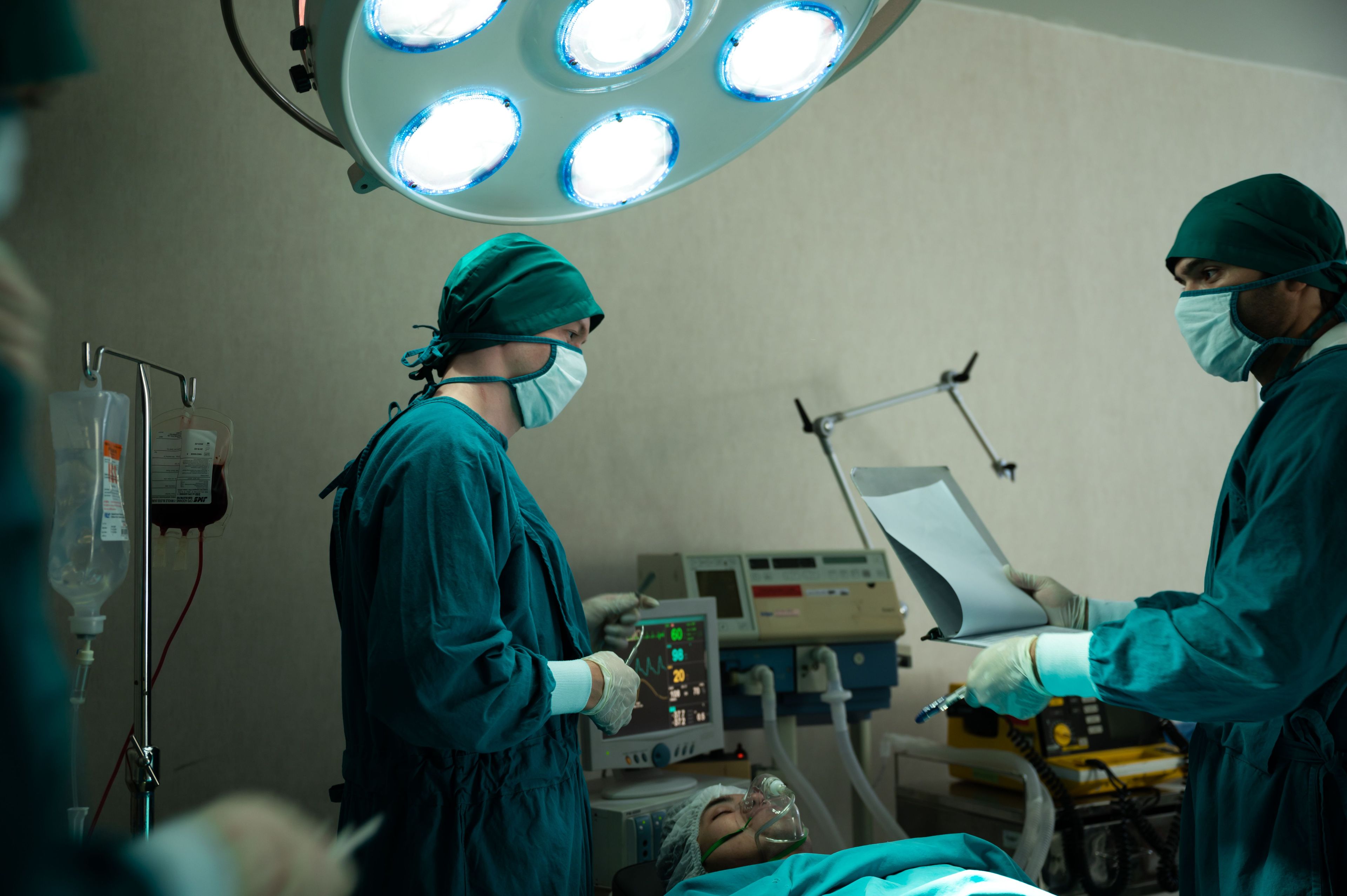 Surgeons preparing patient for spinal fusion surgery