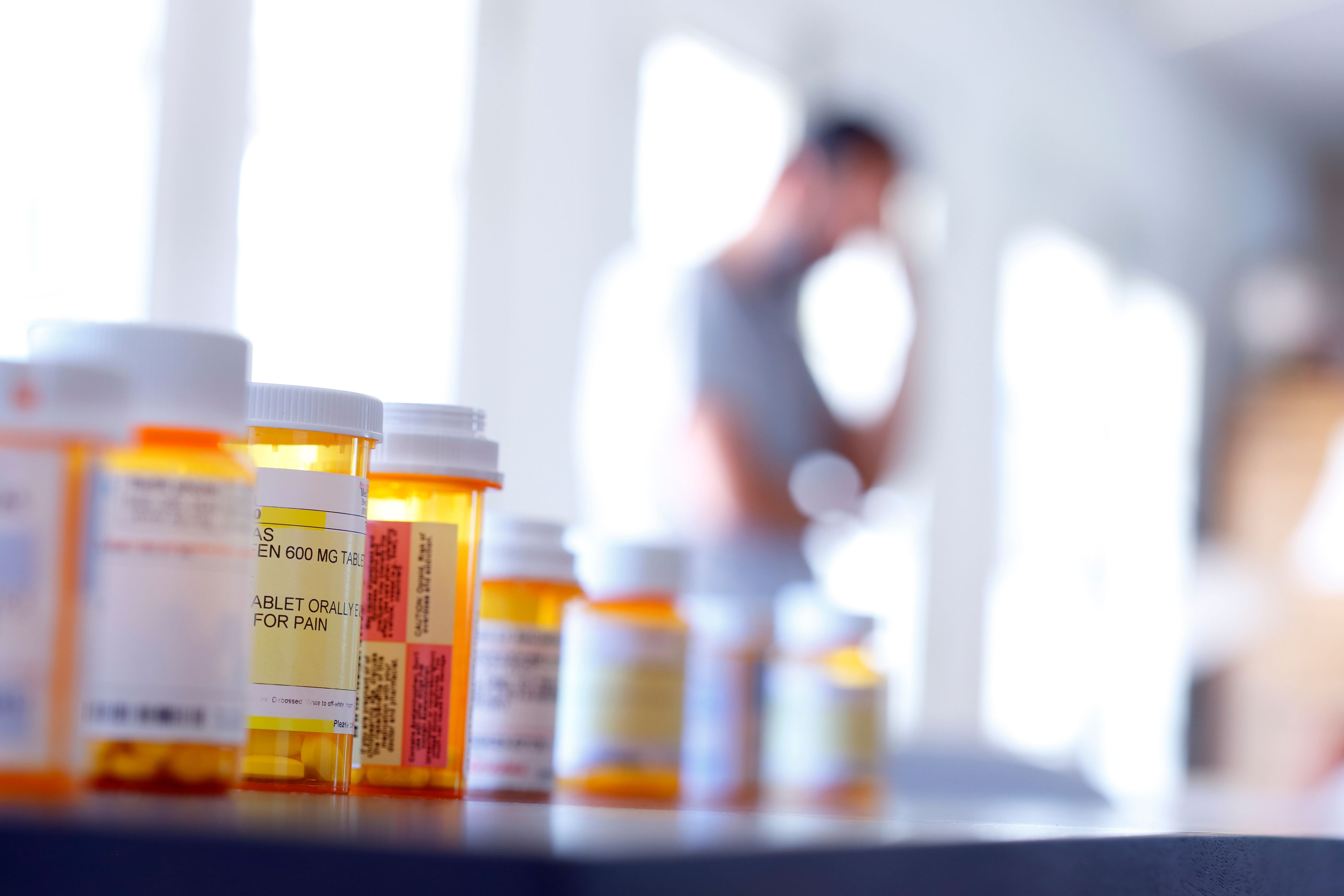 Bottles of prescription pain medication in focus of opioids and pain medications.