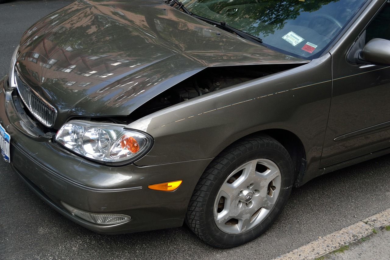 Gray car with damage to the front driver's side.