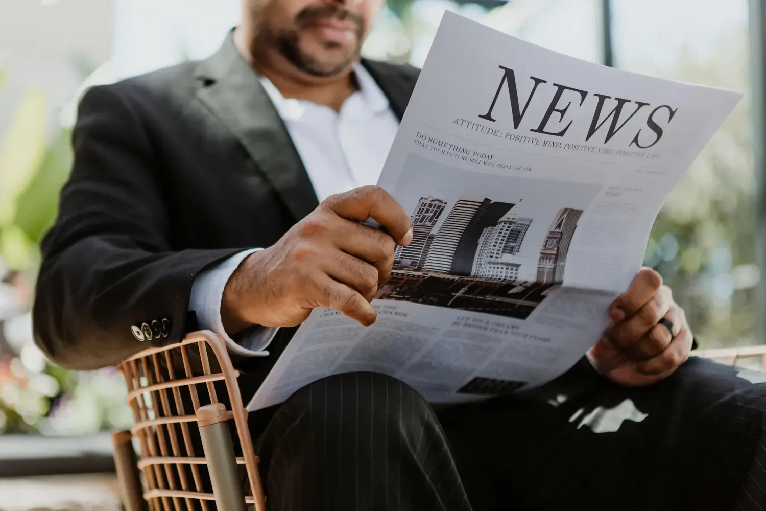 A picture of person reading a news paper.