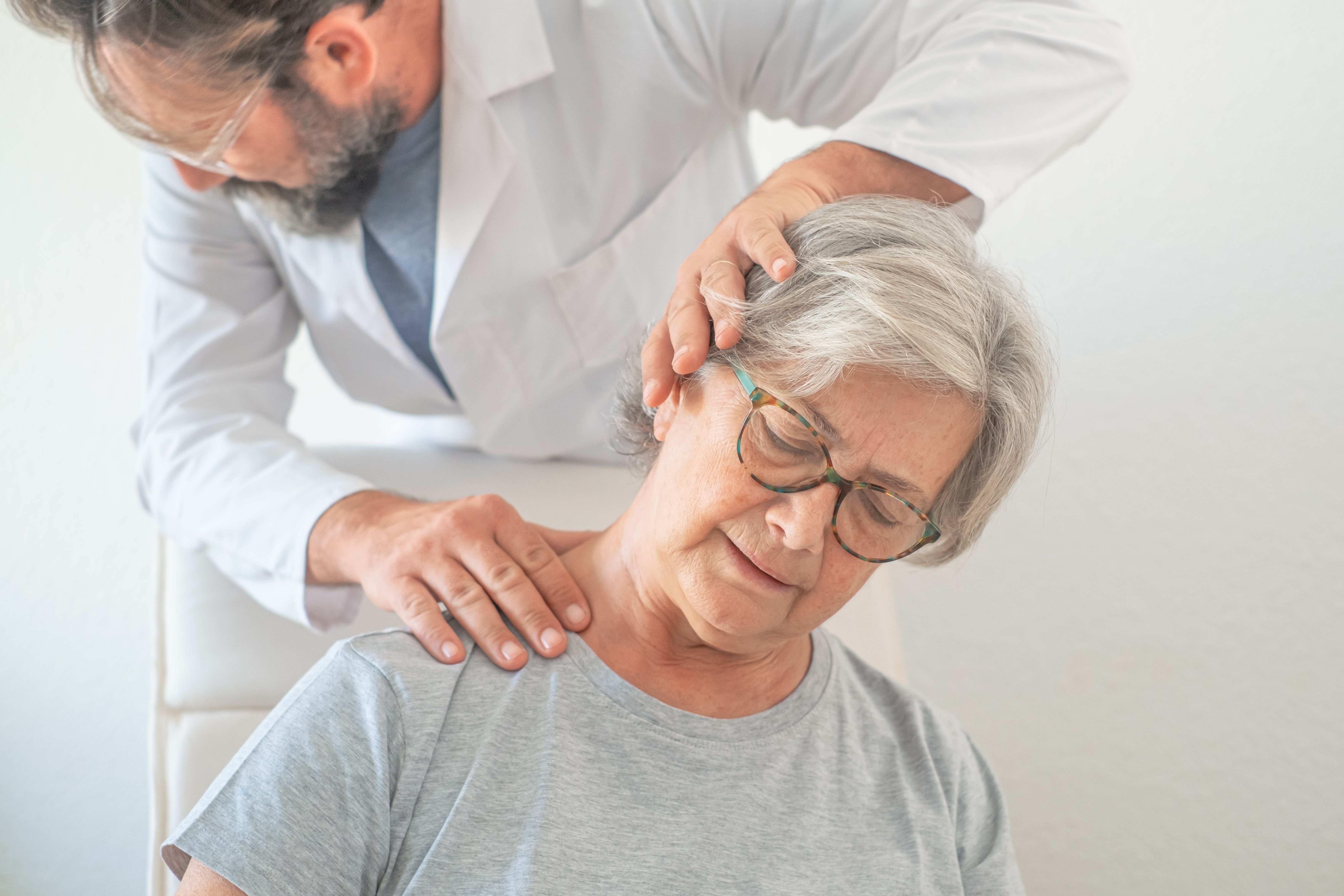 Spine surgeon examining patient with neck pain